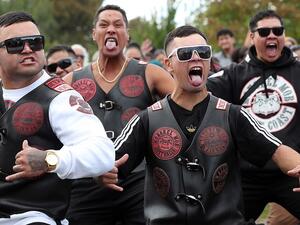A notorious motorcycle gang (pictured performing a haka at the Jamia Masjid mosque in Hamilton on the North Island) stood guard outside the mosque on Friday in a moving display of solidarity after the Christchurch terror attack (AFP)