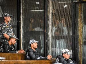 Members of Egypt's banned Muslim Brotherhood are seen inside a glass dock during their trial in the capital Cairo on July 28, 2018. (AFP/Khaled Desouki)