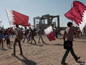 Young people with Qatar flags (AFP/File Photo)	