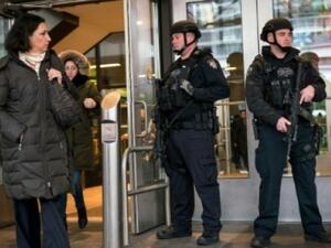 Police stand guard at an entrance to the  bus terminal in New York (AFP/File Photo)