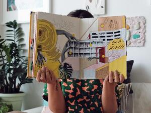 Nahla Tabbaa holds Daftar Asfar. The first edition, along with other editions of the sketchbook, will go on display in Dubai, on Wednesday (Photo courtesy of Nahla Tabbaa)