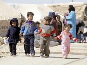 Syrian children walk amid tents at the Zaatari refugee camp, near the Syrian border with Jordan in Mafraq. (AFP)