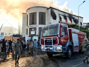 A firetruck and security officers at the scene of an attack on the Libyan foreign ministry in Tripoli on December 25, 2018 (AFP/Mahmud TURKIA)