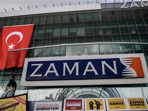 The logo of Turkish daily newspaper Zaman is seen on the headquarters building as people demonstrate in support of the newspaper in Istanbul on March 4, 2016. (AFP/File)