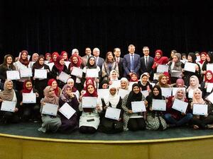 Graduates of a women’s vocational training programme pose for a photo with their certificates on Thursday (Photo courtesy of UN Women)
