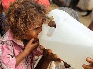 A Yemeni girl drinks water collected from a well in an impoverished village on the outskirts of the port city of Hudaydah. (AFP)