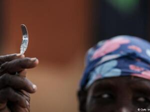 A woman with a rough blade used for FGM in Uganda. (AFP/ File)