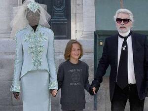 Adut Akech (pictured left alongside Karl Lagerfeld and his godson), 18, from Sudan has become only the second black model to walk the runway as the Chanel bride (AFP/File Photo)	