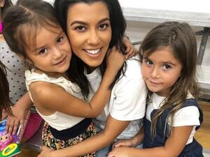 Kourtney Kardashian (middle), 39, brought her daughter Penelope, six (right), to the Watts Empowerment Center this Wednesday, where the little girl 'made a new friend' (left) (Instagram)
