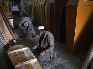 A carpenter builds a coffin in his workshop (AFP/File Photo)