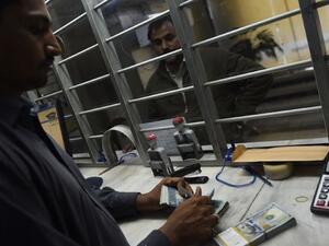 A dealer counts money at a currency exchange (AFP/File Photo)	