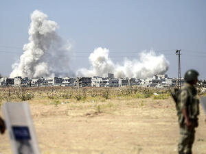 Smoke rises in the Syrian city of Kobani from heavy fighting seen from the Turkish border. (AFP/File)