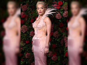 Ruffling feathers: Rita ensured she took centre stage in her bodycon dress, featuring a dramatic feathered collar, with matching detailing running down the bodice and her hips (Source: David Fisher - REX - Shutterstock)