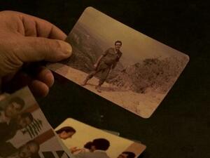 The Kataeb's former intelligence chief Assaad Chaftari looks through his wartime photos in a scene from Rugo and Weaver's doc "About a War." (Photos courtesy of Iterations Films)