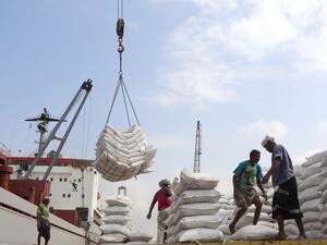 Workers unload food aid provided by Unicef from a cargo ship in war-torn Yemen's main port of Hodeida in January. (AFP/ File)
