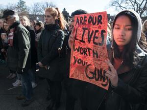  A student holds a sign during the protest against gun violence (AFP/File Photo)