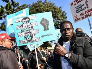 People, including employees of the country's social and reception centers and members of anti-racism associations, march during a demonstration against the government's social politics, its recent decree restricting the right to asylum, and against racism on November 10, 2018 in downtown Rome. 
Alberto PIZZOLI / AFP