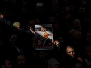 A person holds a banner of Jamal Khashoggi during a symbolic funeral prayer for the Saudi journalist (AFP)