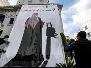 This picture taken on November 26, 2018 shows a giant banner hanging at the headquarters of Tunisia's Journalists Union in the capital Tunis depicting a cartoon of Saudi Crown Prince Mohammed bin Salman (AFP)