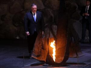 US Secretary of State Mike Pompeo stands next to the eternal flame at a ceremony commemorating the six million Jews killed by the Nazis during the Holocaus (AFP)