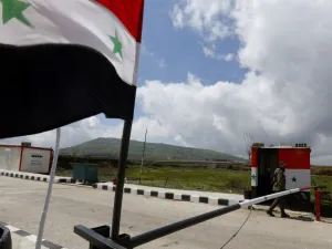 A member of the Syrian security forces walks near the border post with Israel in the Syrian town of Quneitra in the Golan Heights  (AFP)