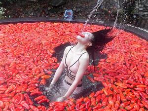 This girl is on fire: A woman takes part in the chilli-eating contest at a scenic spot in Yichun city, Jiangxi province on Sunday (Instagram)