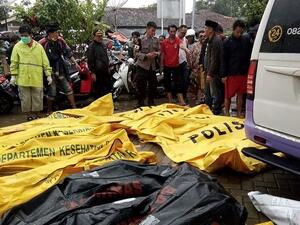 Bodies of victims recovered along Carita beach are placed in body bags as families search for the missing on Sunday morning (AFP)