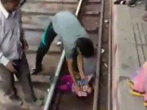 The girl is seen crying on the tracks at a railway station at Mathura after getting stuck in between the tracks (Twitter)