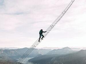 Daredevils scale wobbly ladder strung between two mountains  (Twitter)