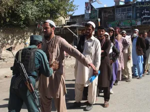 An Afghan policeman searches voters before casting their votes at a polling centre for the country's legislative election in Khost Province on October 20, 2018. (AFP/File)