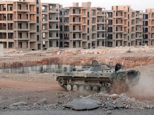 An opposition tank drives through a government-held neighborhood in Aleppo on August 5, 2016. (AFP/Omar Haj Kadour)