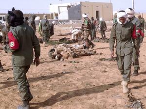 Soldiers attend to wounded and casualties in the aftermath of a suicide bomb attack who ripped through a camp grouping former rebels and pro-government militia in troubled northern Mali left 40 people dead on January 18, 2017 in Gao. (AFP/Stringer)