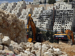 Israeli construction cranes and excavators at a building site of new housing units in the Jewish settlement of Neve Yaakov (AFP)