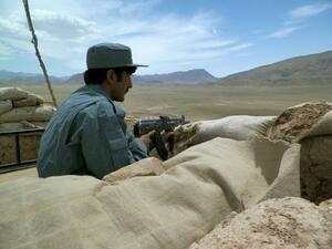 An Afghan policeman observes the Tarin Kot highway in central Afghanistan. (AFP/File)