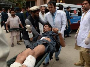 Afghan volunteers carry an injured youth on a stretcher to a hospital, following an attack that targeted a parliamentary election rally in the Kama district of the eastern province of Nangarhar, in Jalalabad on October 2, 2018. (NOORULLAH SHIRZADA / AFP)