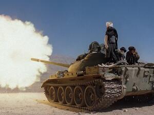 Taliban soldiers in Russian-made tanks fire on the forces of former Afghan defense minister. (AFP)