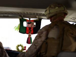 A US soldier drives a bus ahead of handover ceremony at Leatherneck Camp in Lashkar Gah in the Afghan province of Helmand on April 29, 2017. (AFP/Wakil Kohsar)