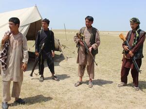 Members of an Afghan militia look on during fighting between Taliban militants and Afghan security forces near the Qala-e-Zal district in Kunduz province on May 7, 2017. (AFP/Bashir Khan Safi)