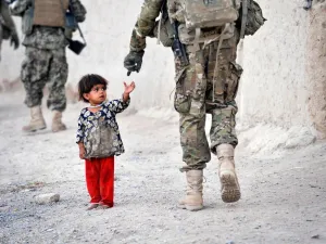 An Afghan girl greets a joint patrol of US troops from the Charlie Company. (AFP/ File)