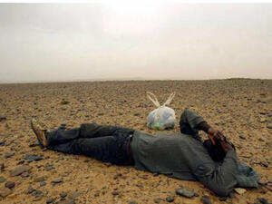 A travelling migrant resting in the middle of the Sahara Desert, near the border with Algeria. (AFP/ File Photo)