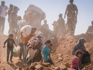 Syrian refugees at the eastern part of the Jordanian border in 2014 (AFP/UNHCR)