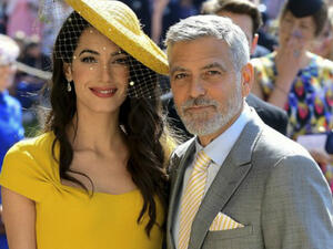 The 57-year-old actor and his wife Amal were invited to watch the former 'Suits' actress tie the knot with Prince Harry (Source: Ian West - POOL - AFP)