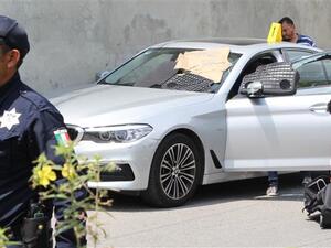 Police and forensic personnel work near the car in which Mexican radio and television journalist Juan Carlos Huerta was killed in Villahermosa, Mexico, on May 15, 2018. (AFP Photo)