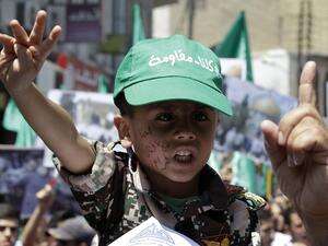 A boy wearing a cap reading in Arabic: '"We are all resistant" takes part in a demonstration by Jordan's Muslim Brotherhood (AFP/File)