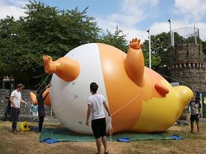 Activists inflate the giant orange balloon in north London ahead of a demonstration set to coincide with Trump's visit  (AFP/File Photo)