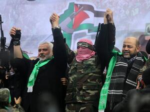 Hamas leaders Ismail Haniya (L), Abu Obaida (C) and Mussa Abu Marzuq (R) greet supporters. (AFP/File) 
