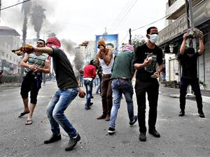 Palestinian stone throwers clash with Israeli security forces following Friday prayers on Friday, in West Bank town of Hebron. (AFP/File) 