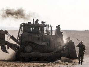 An Israeli D9 bulldozer rolls along the southern Israeli border with the Gaza Strip following Israeli airstrikes on the Gaza Strip on July 10, 2014. (AFP/Jack Guez)