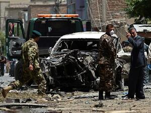 Afghan security forces inspect a damaged vehicle at the site of a bombing in the capital city of Kabul, July 7, 2015. (AFP/File) 