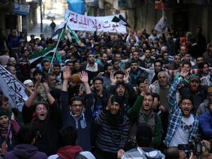 Anti-regime protesters take advantage of the ceasefire to stage a protest in a rebel-held neighborhood of Aleppo. (AFP/Karam Al-Masri)